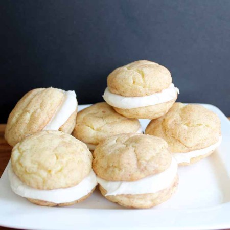 Snickerdoodle whoopie pies on a white plate