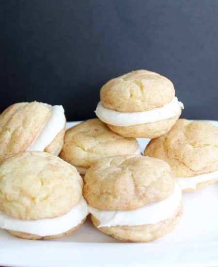 Snickerdoodle whoopie pies on a white plate