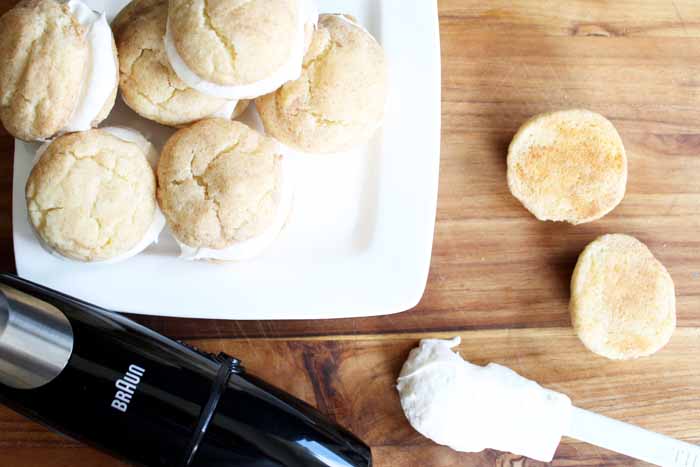 White square plate of snickerdoodle whoopie pies on a wooden backdrop