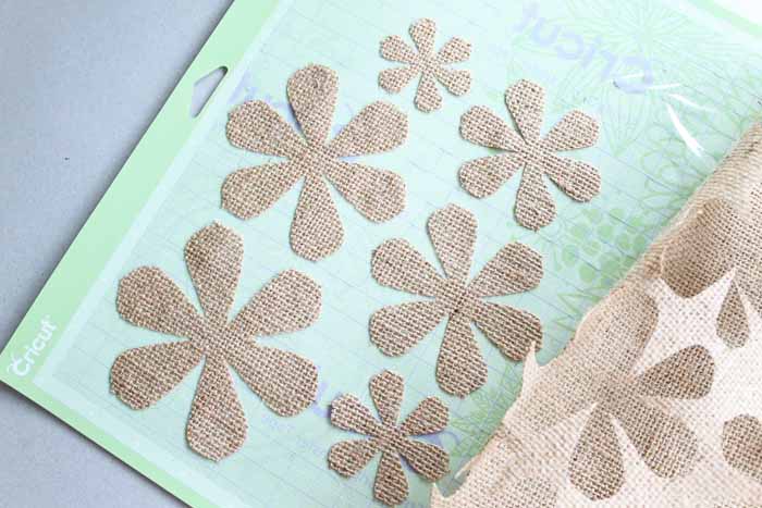 burlap flower pieces on Cricut cutting mat 