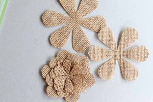 pieces of a burlap flower on a gray backdrop
