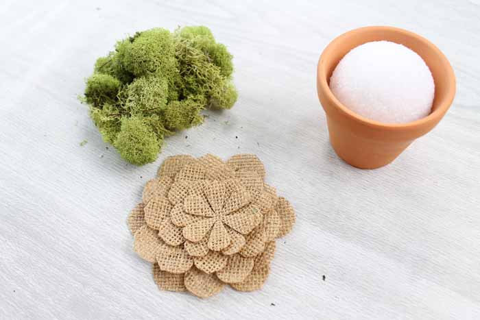 pieces used to assemble a burlap flower in a terra cotta pot