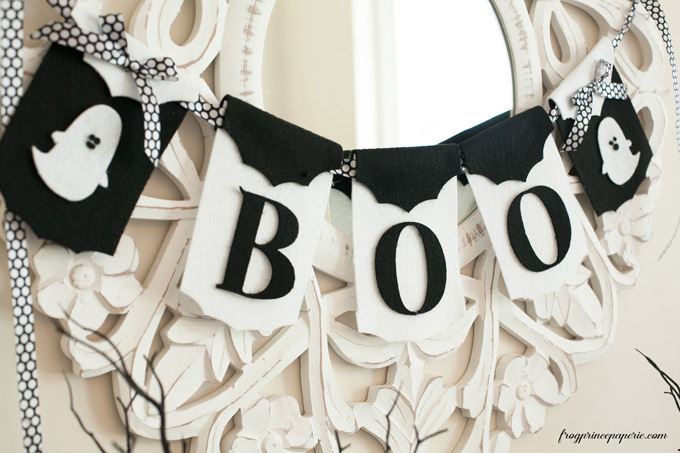 white boo sign with bats on top hung on white mirror