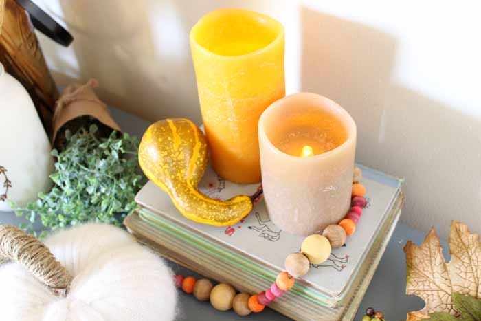 Lit candles on a stack of books