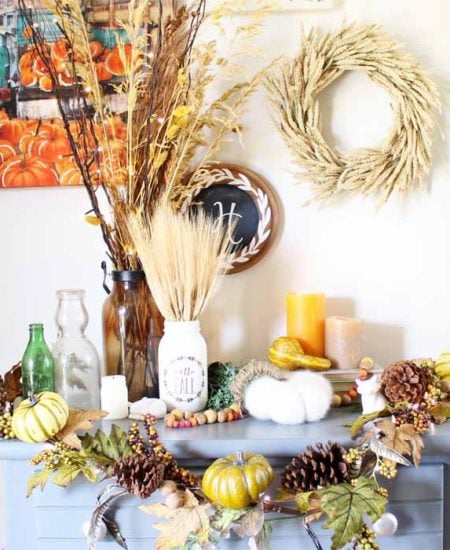 Blue table with wheat centerpiece and fall home accessories