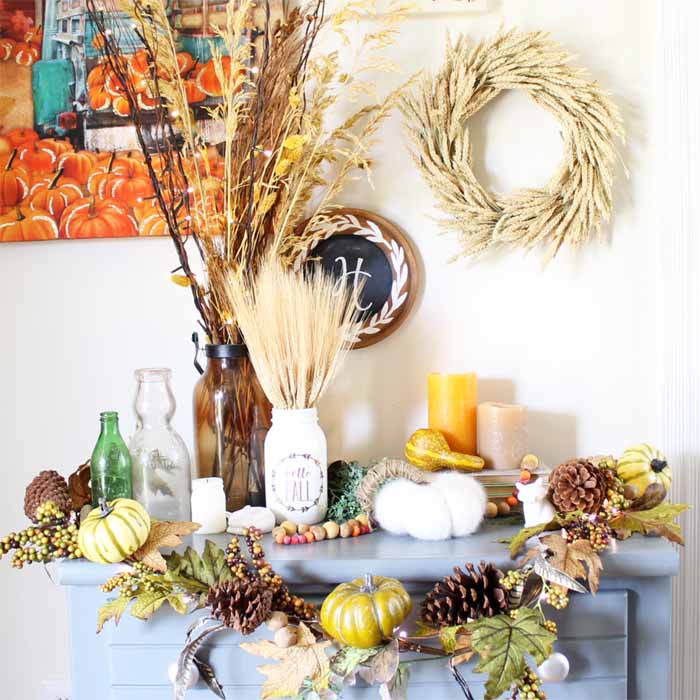 Blue table with wheat centerpiece and fall home accessories