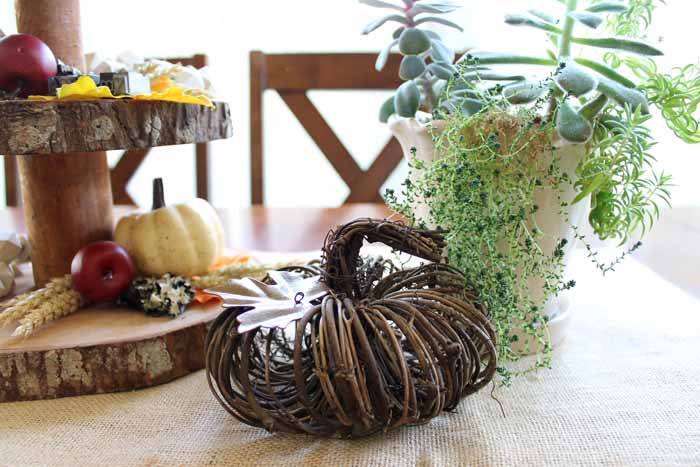 willow pumpkin in front of pot on table