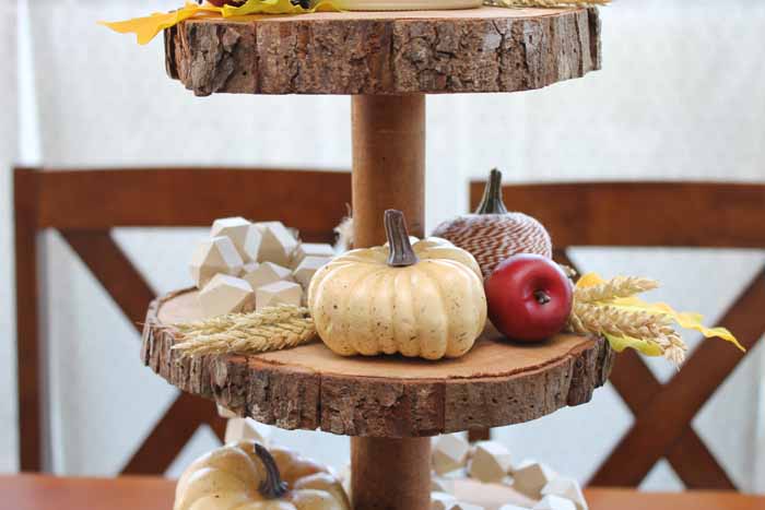 tiered wood slice tray with faux pumpkins