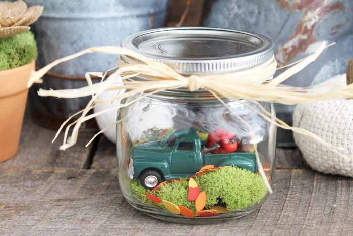close up of a fall snow globe in a mason jar