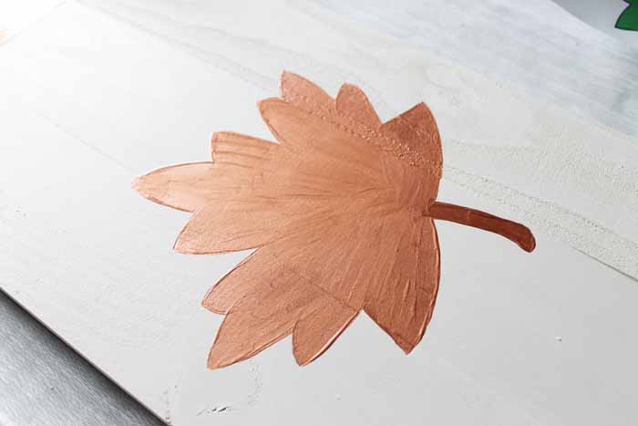 painted metallic brown leaf on unfinished wood 