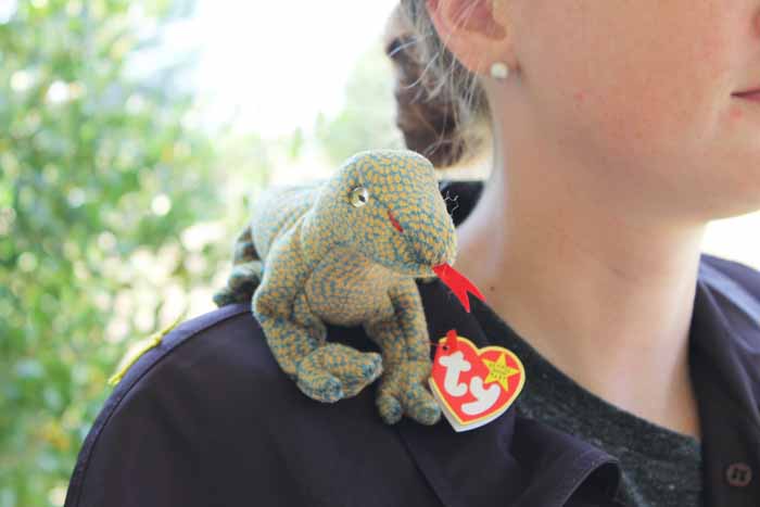 A woman holding a stuffed animal for a costume