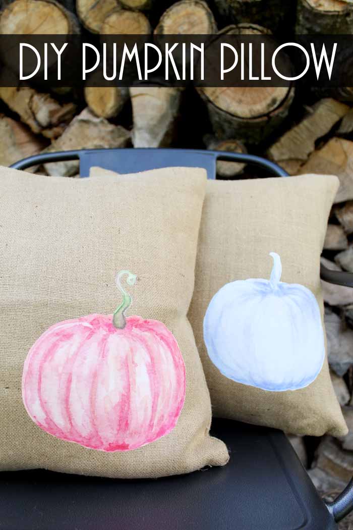 burlap pillows with watercolor pumpkins in front of logs