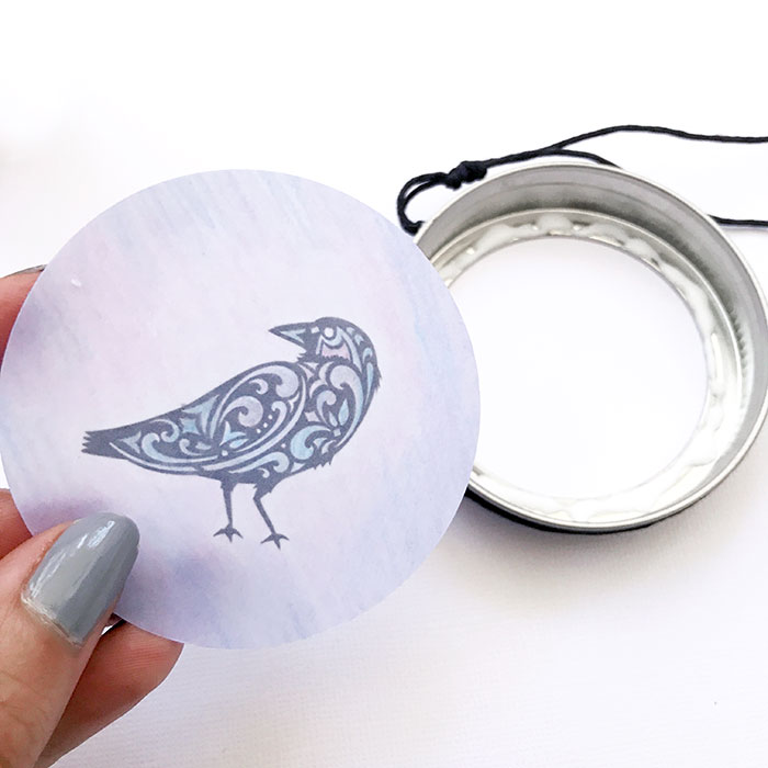 Raven circular cutout and mason jar lid on white background