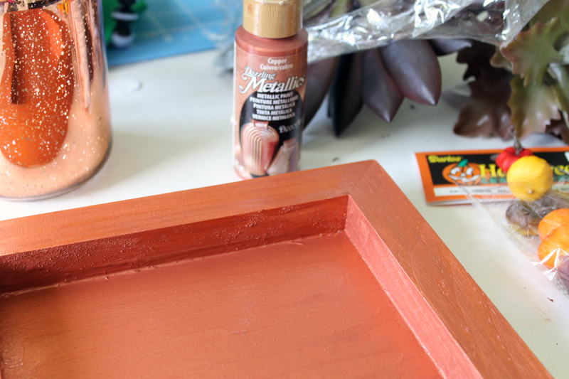 orange painted frame on wooden backdrop