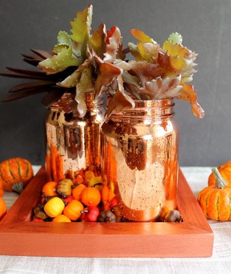 mason jars in orange tray with pumpkins