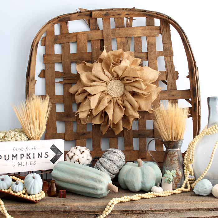 tobacco basket with burlap flower, wheat, painted pumpkins and wood bead garland 