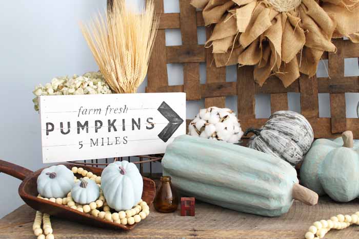 fall decor items with painted pumpkins, pumpkins sign and wheat