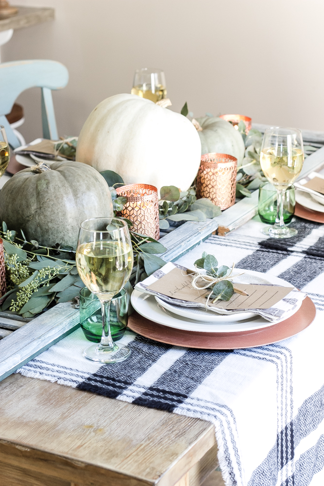 metallic copper and pumpkins on a table