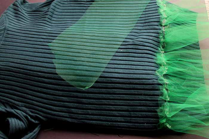 adding green tulle to sweater with hot glue 