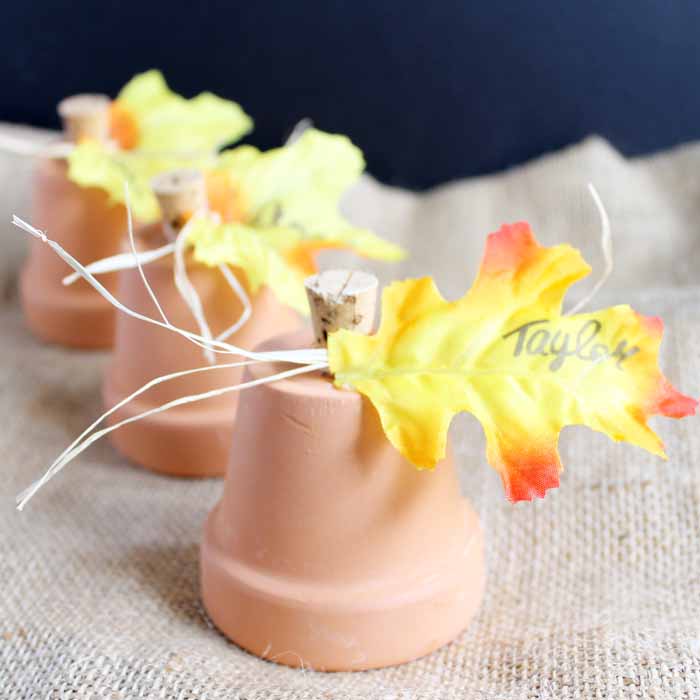 A close up of a diy clay pot place card on burlap