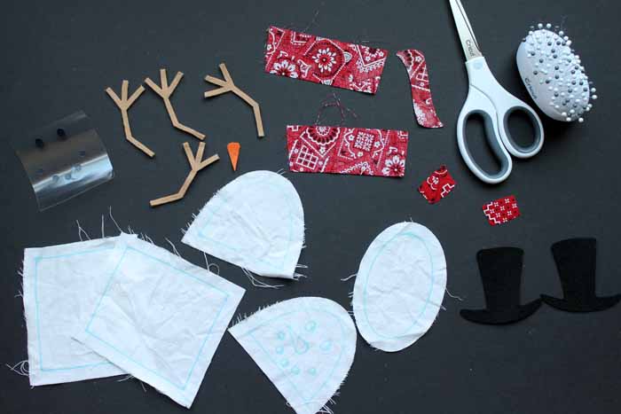 pieces of a standing snowman on a black background