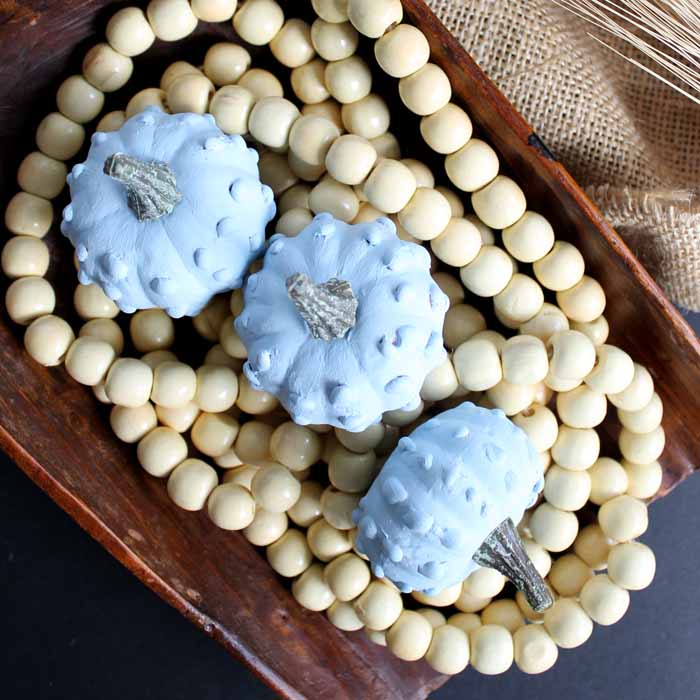 top view of diy blue gourds on wooden beads in a bread bowl