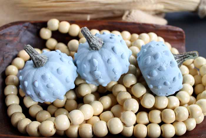 a trio of blue painted gourds on wooden beads for diy fall decor