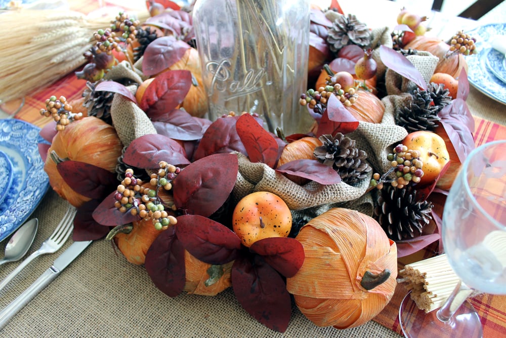 This Thanksgiving centerpiece uses an affordable Fall wreath as a focal point.