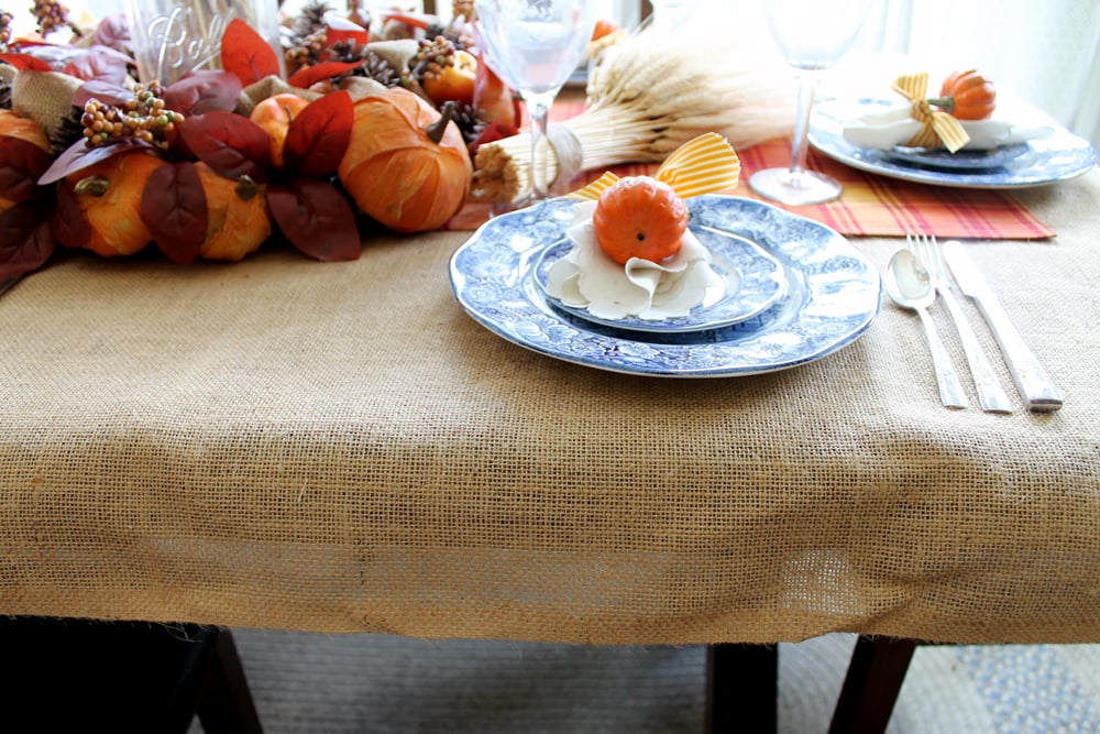A simple burlap tablecloth is the base of this DIY thanksgiving tablescape