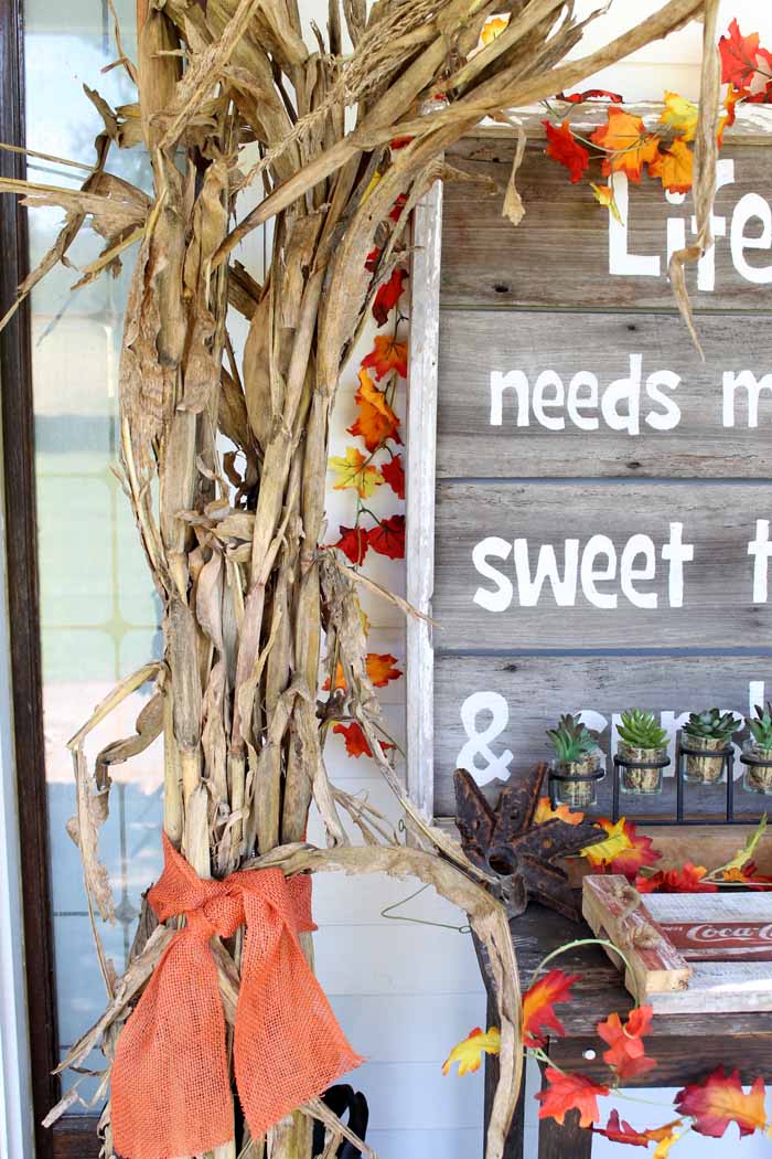 fall front porch with corn husks and leaf garland rustic display sign