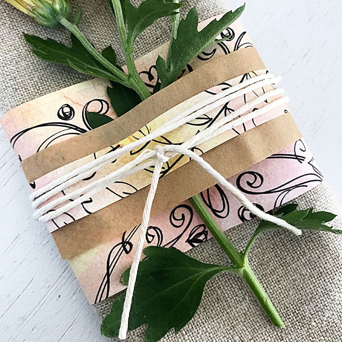 adding floral stems to a napkin ring