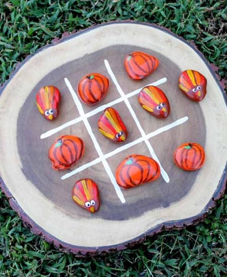 Wood slice with painted rocks for a tic tac toe game