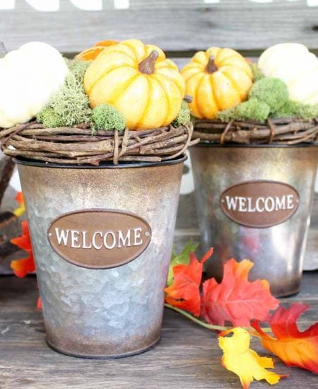 grapevine wreaths on metal buckets with welcome on the front