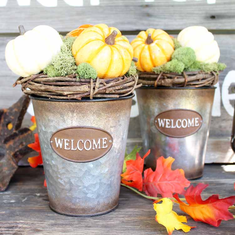 grapevine wreaths on metal buckets with welcome on the front