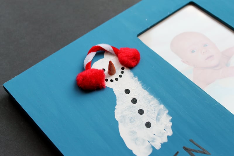 snowman made with a footprint on baby photo frames