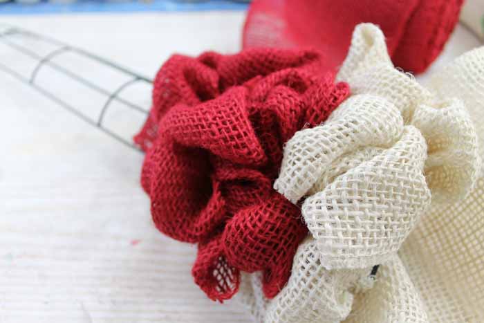 red and white burlap ribbon on a wreath form