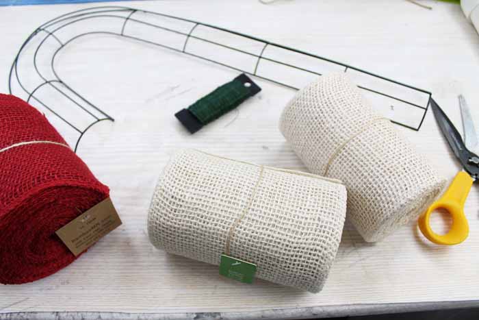 wire wreath form and burlap ribbon on a table