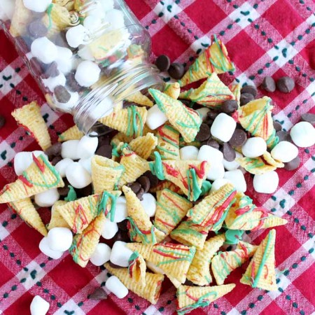 christmas crunch trail mix spilling from a jar