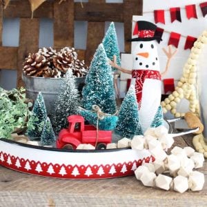 metal tray with christmas trees and a fabric snowman