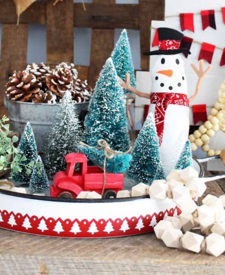 metal tray with christmas trees and a fabric snowman