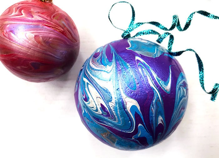 paint marbled ball ornaments on a table