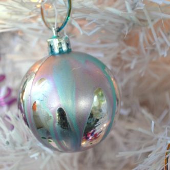 marbled glass ball ornaments on a white tree