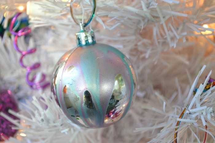 marbled glass ball ornaments on a white tree