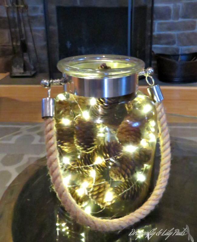 jar filled with lights and pinecones