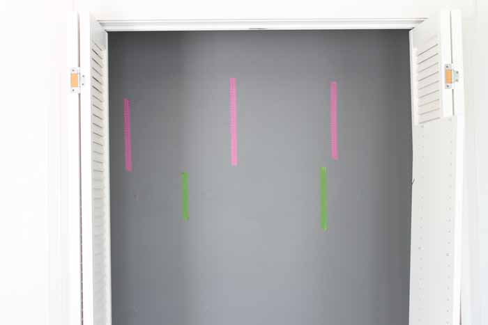 adding painter's tape on the wall for closet placement