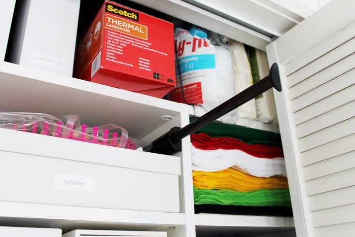rod in a closet organizing craft supplies