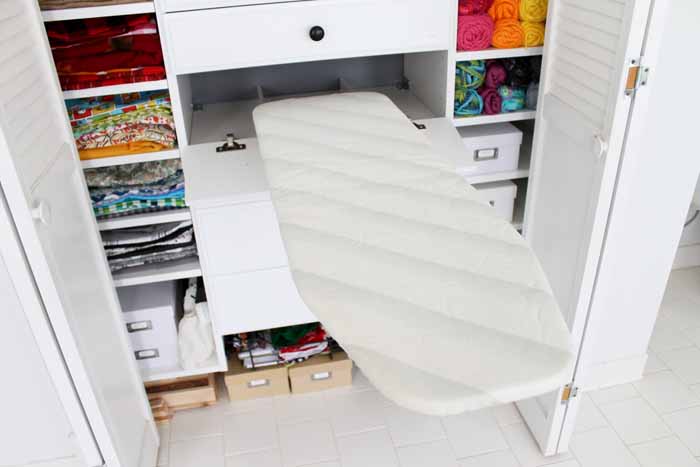 ironing board in a drawer in a closet