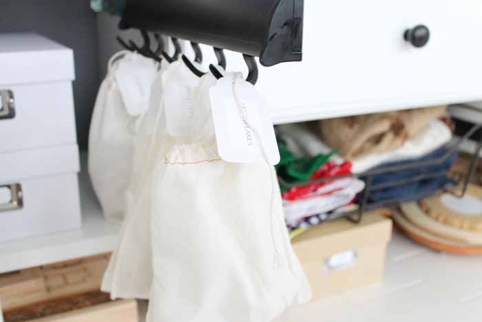 fabric bags hanging on a closet organizer