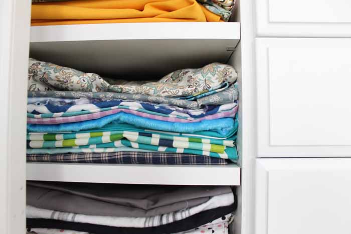 fabric on shelves in a closet