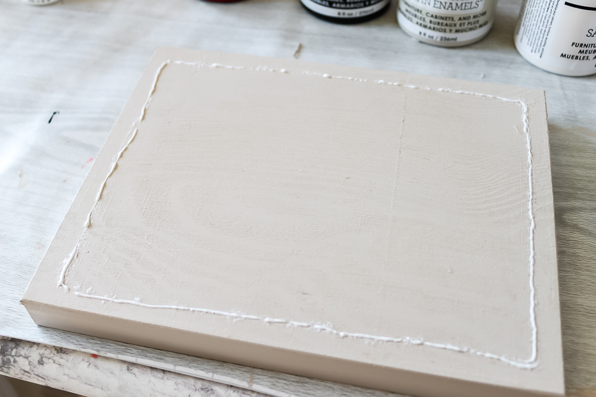 adding glue to wood panel